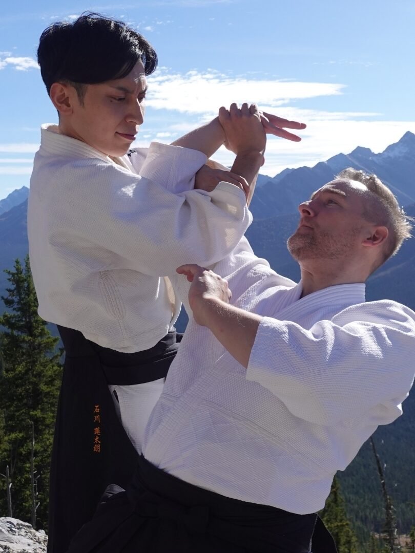 Rentaro Ishikawa performs an Aikido arm-lock throw during class in calgary