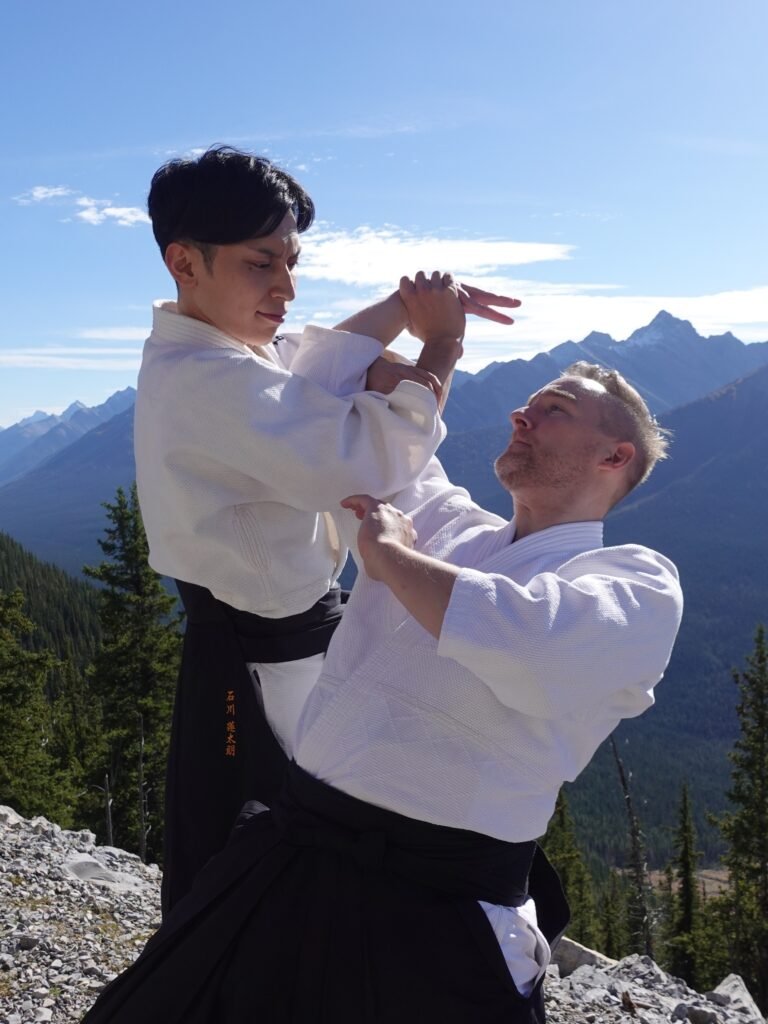 Rentaro Ishikawa performs an Aikido arm-lock throw during class in calgary