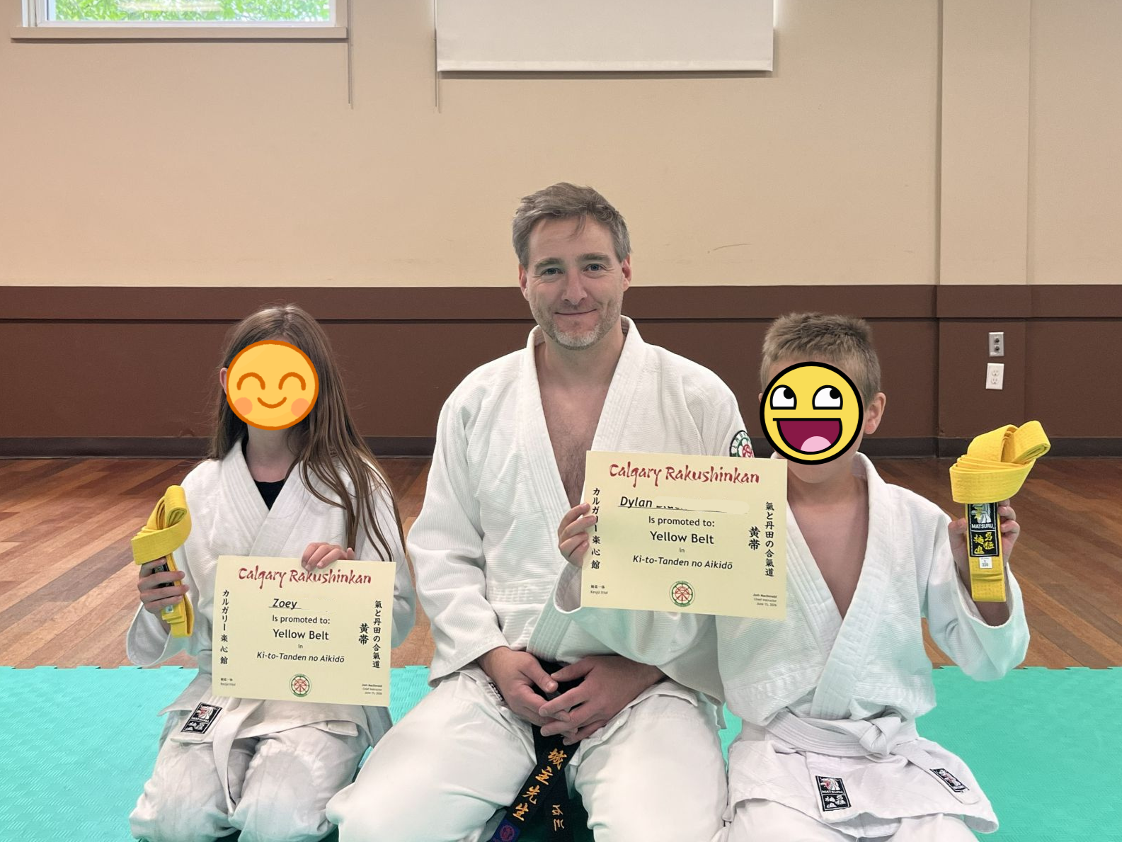 two children promoted to yellow belt